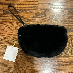 Faux fur black clutch. New Without tags. Zips up. One compartment.